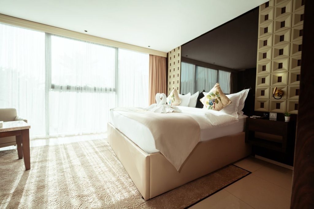 Luxurious hotel room in Baghdad with modern decor and natural light.